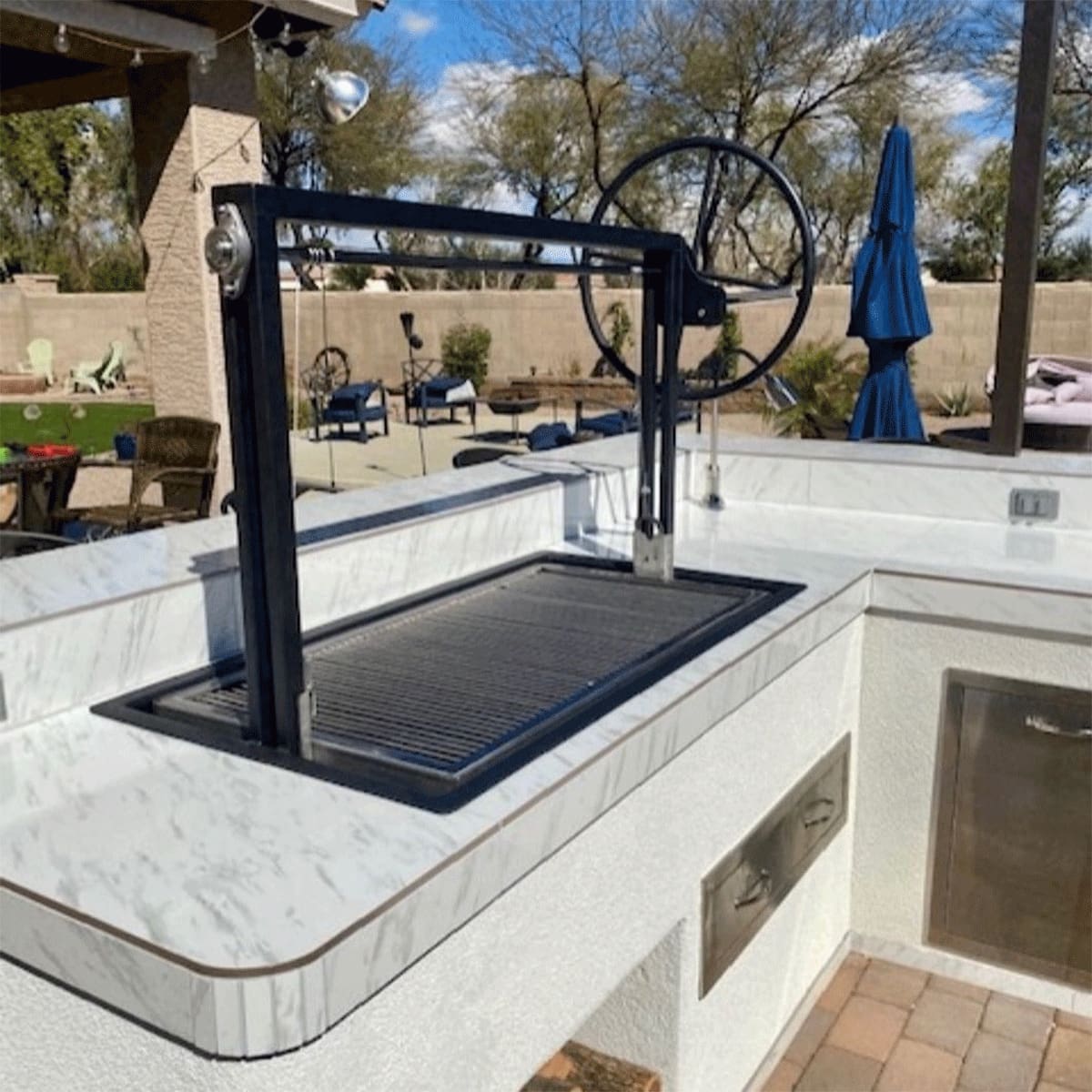 Large, single screen charcoal grill with cable driven assembly.