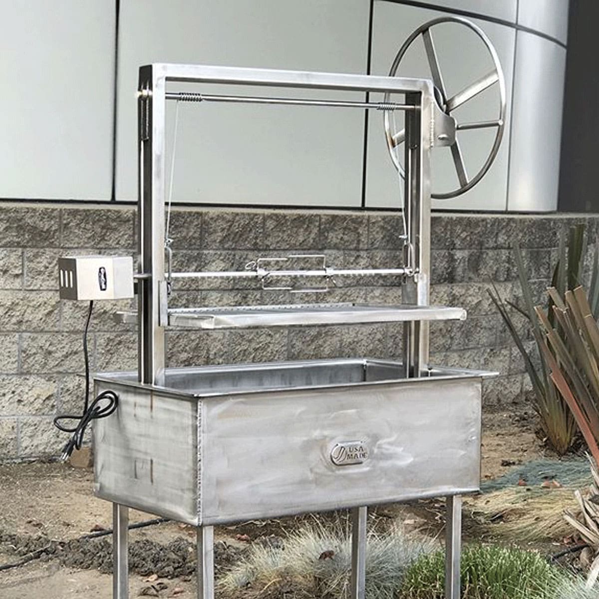 A wood and charcoal grill in stainless with rotisserie compatibility