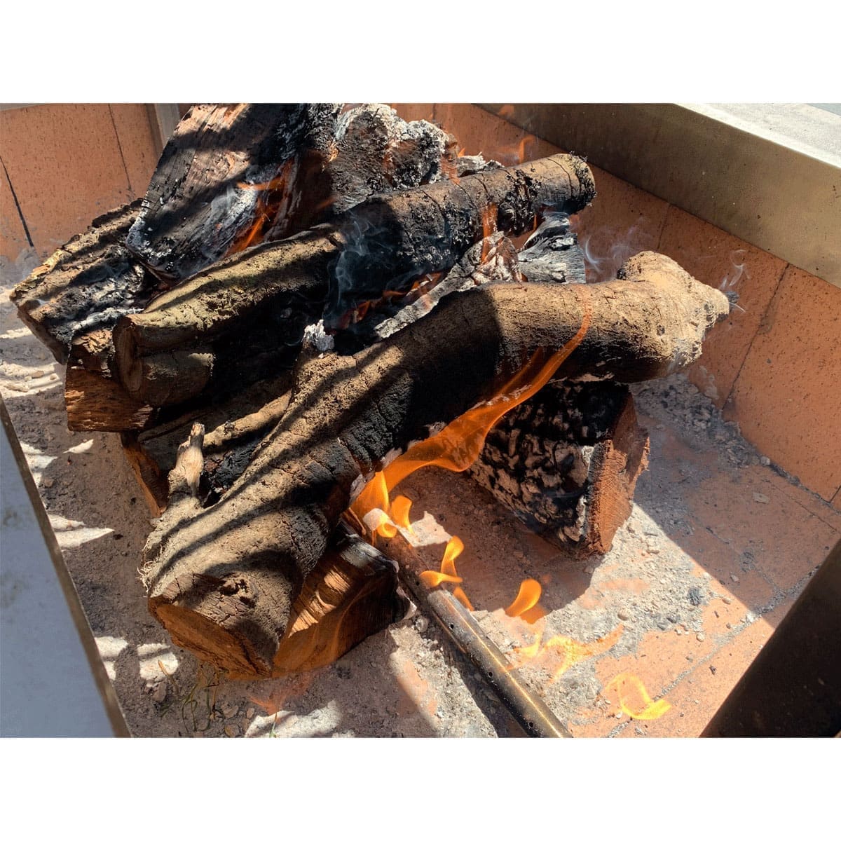 A log lighter can be added to a wood fired grill to make ignition faster.