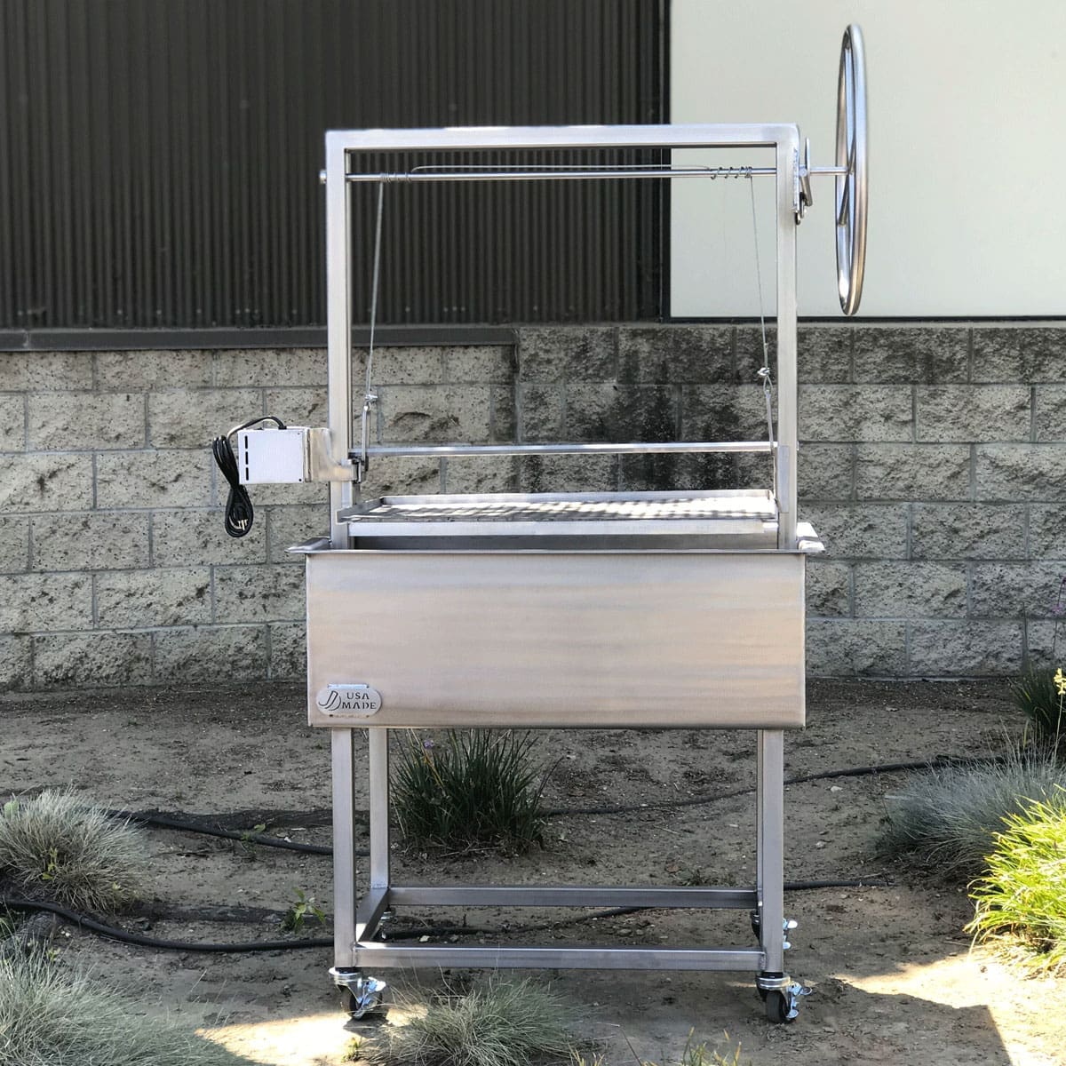 Stainless steel grill cart with rotisserie.