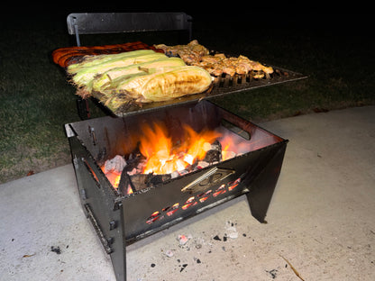 Corn on the cob being grilled on a laser cut grill fire pit with flames visible.