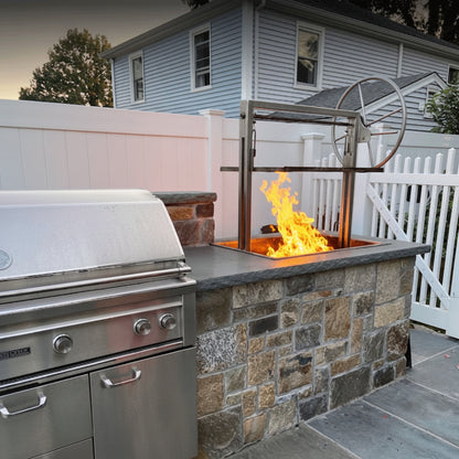 Stainless parrilla with adjustable grill grates for an outdoor kitchen.